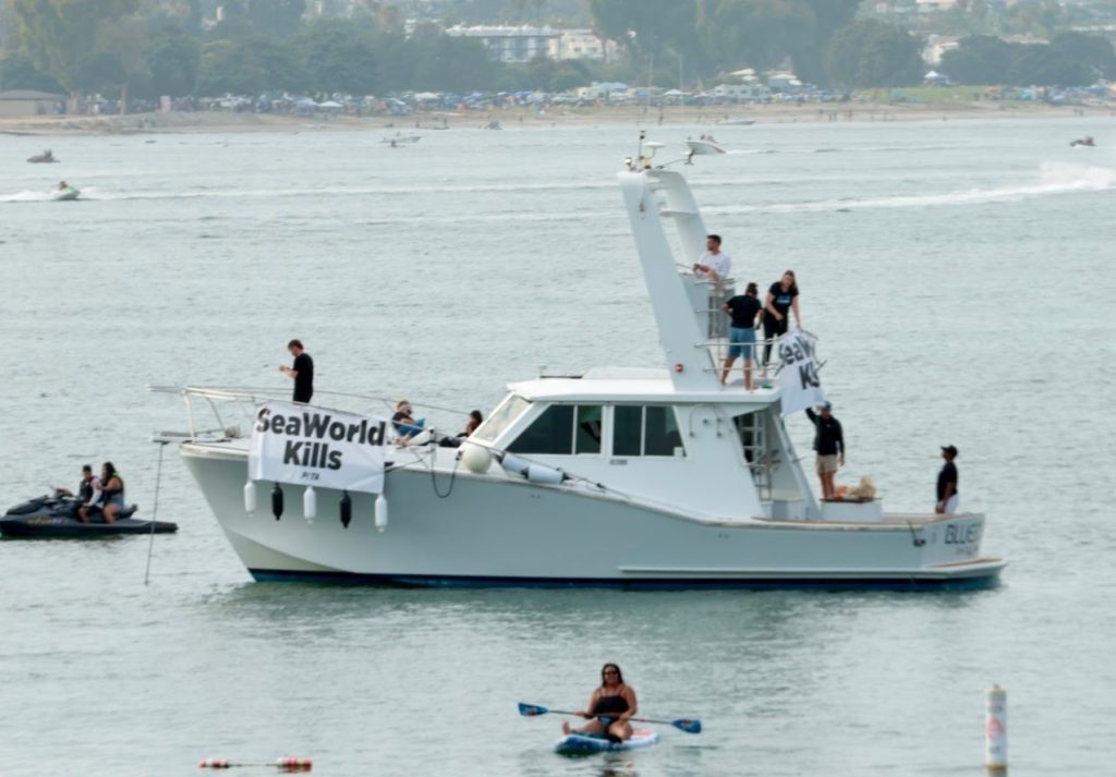 Yacht displaying a PETA SeaWorld Kills banner near SeaWorld San Diego during Ashanti's concert